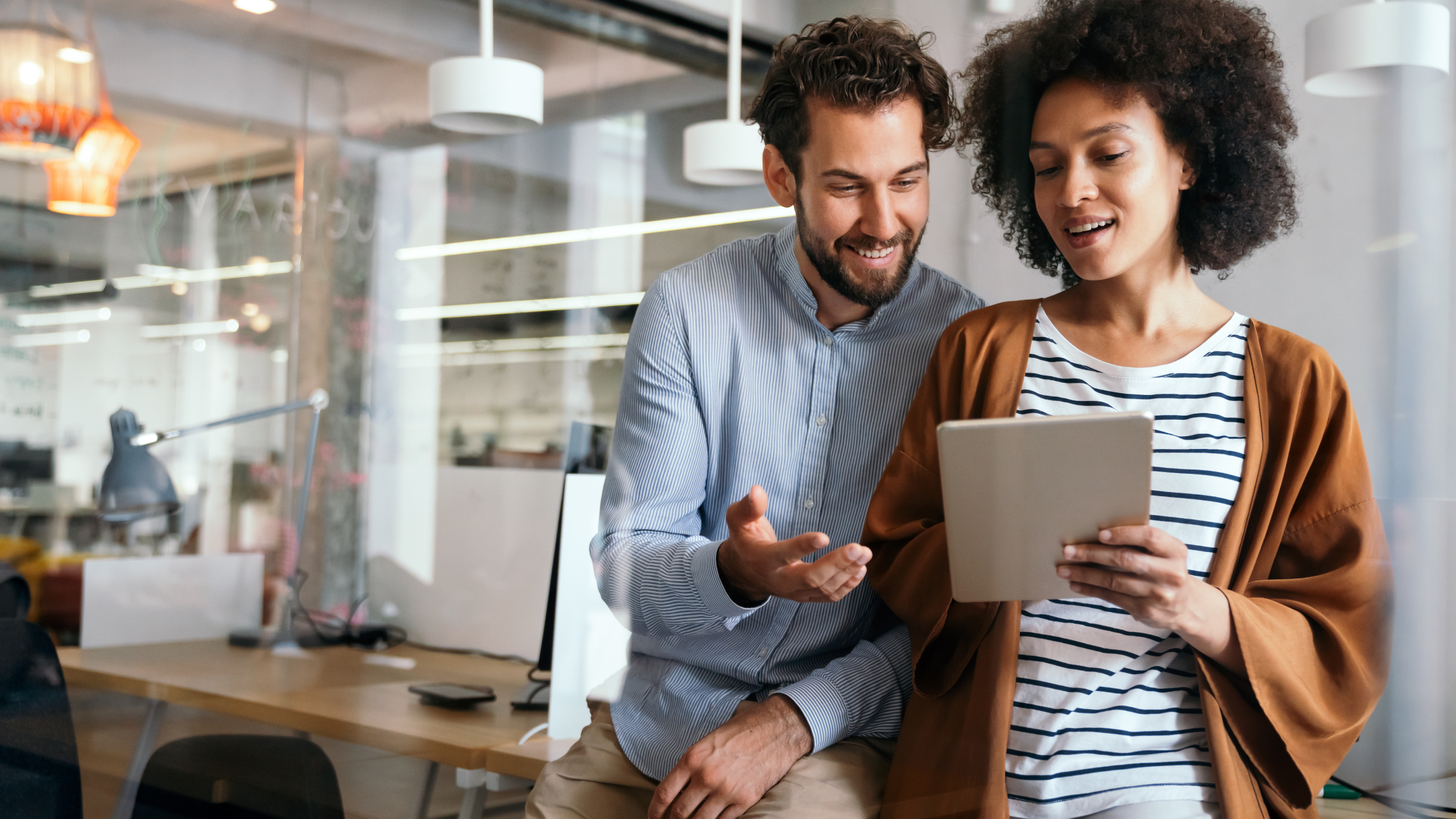 Two people looking at a tablet screen.