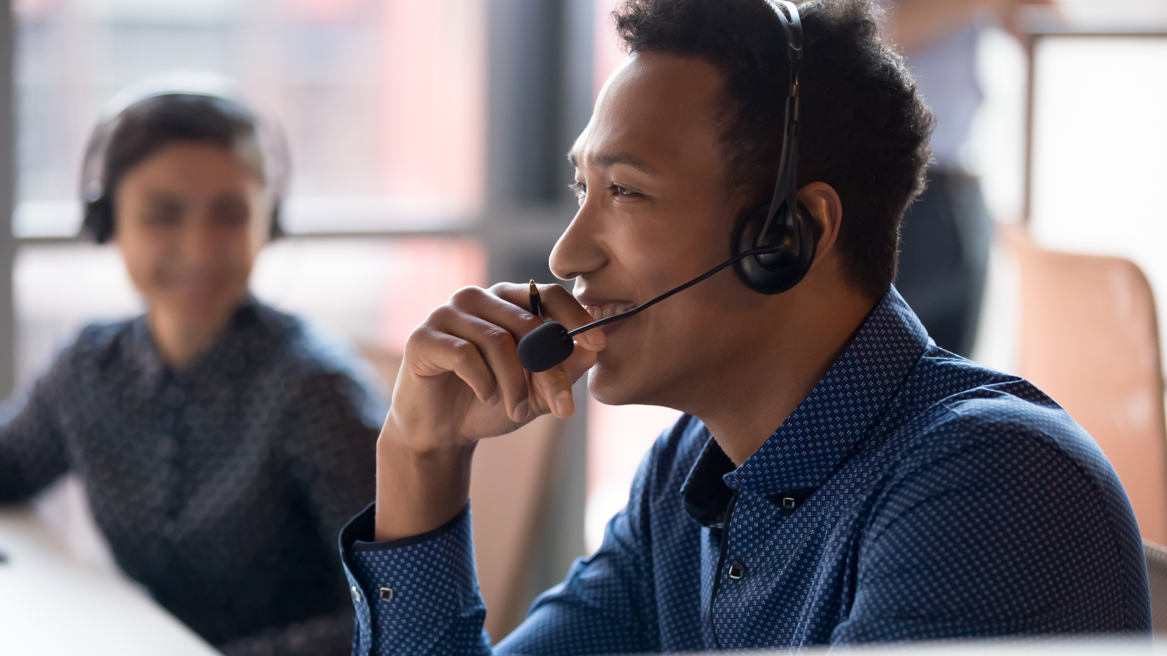 A help desk employee talking on the phone.